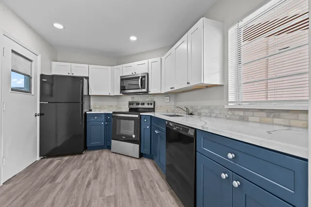 a kitchen with stainless steel appliances a refrigerator sink and microwave