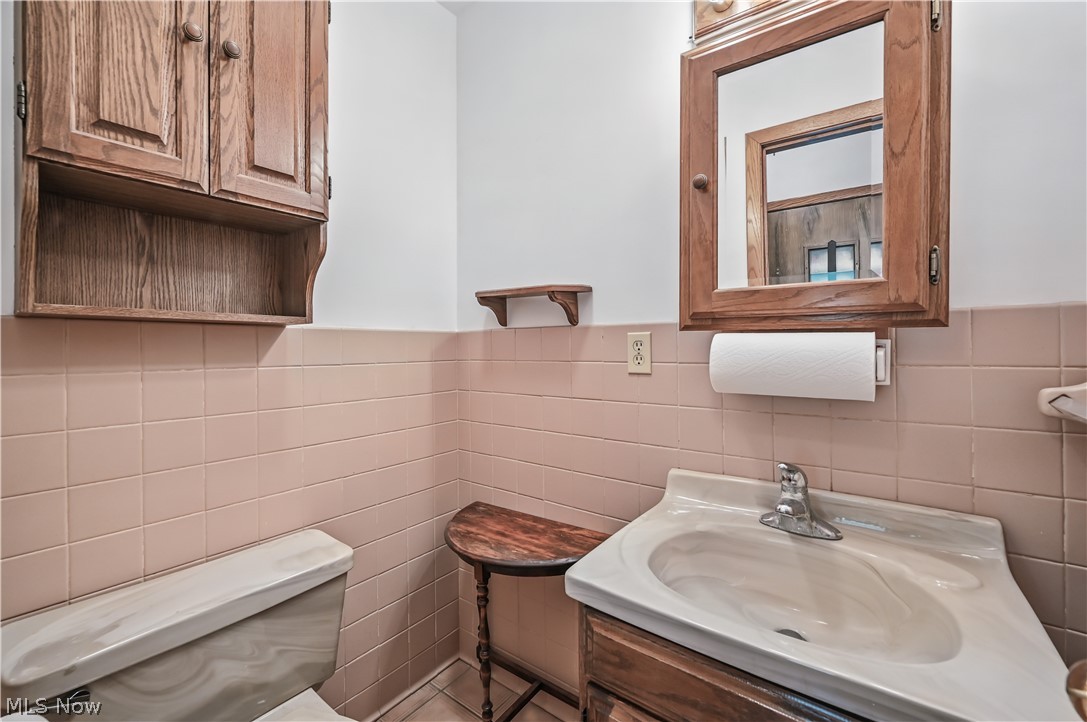 2717 Niles Vienna Road Niles, OH 44446 - Photo 17 of 50 Bathroom featuring tile walls, vanity, and wainscoting