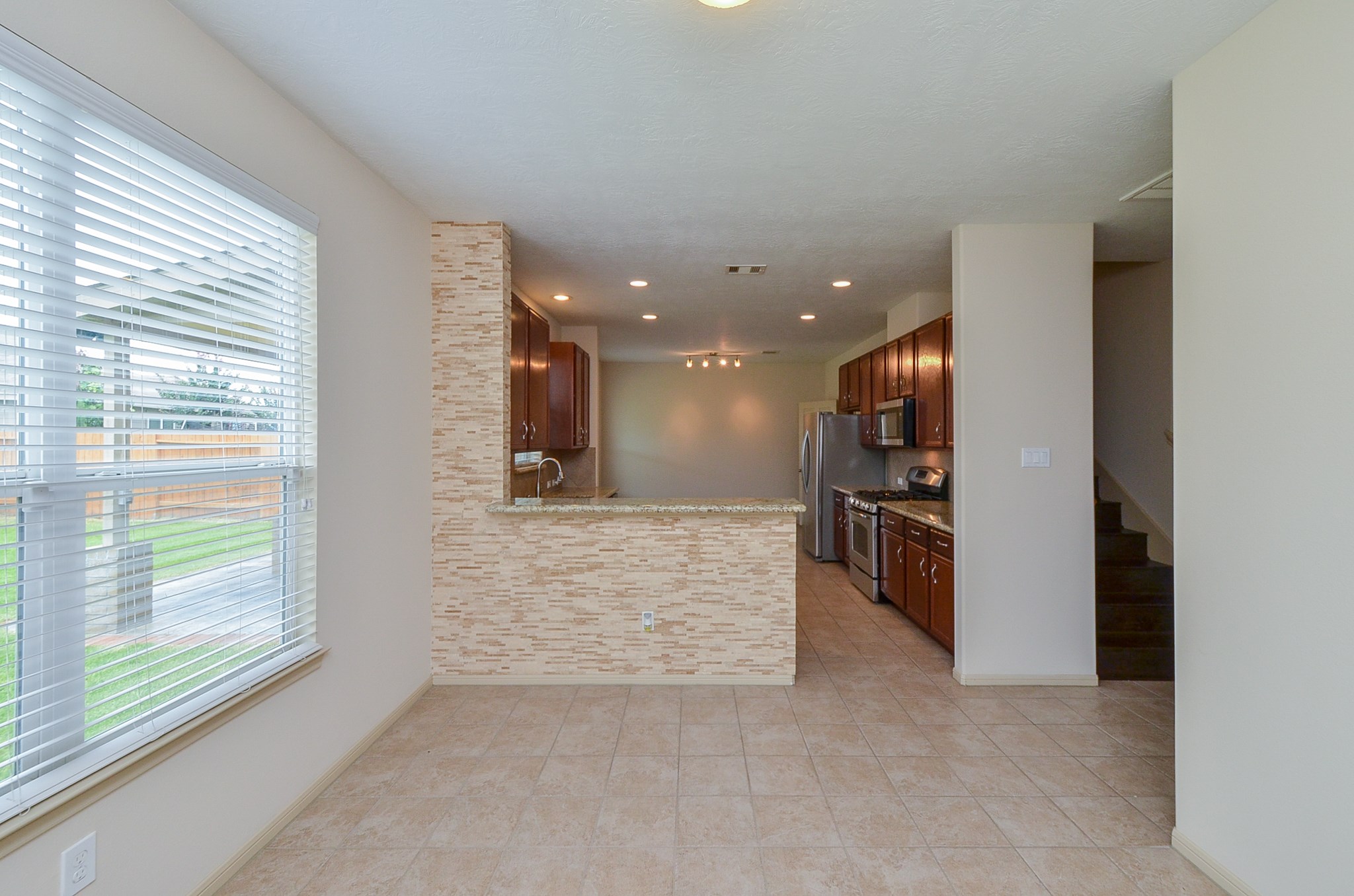 25135 Ginger Ranch Drive Katy, TX 77494 - Photo 12 of 32 The open dining area features tile flooring and natural light.
