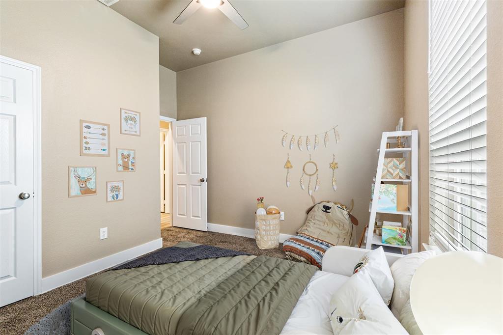 413 Henderson Street Bonham, TX 75418 - Photo 13 of 27 a bedroom with a bed and a window