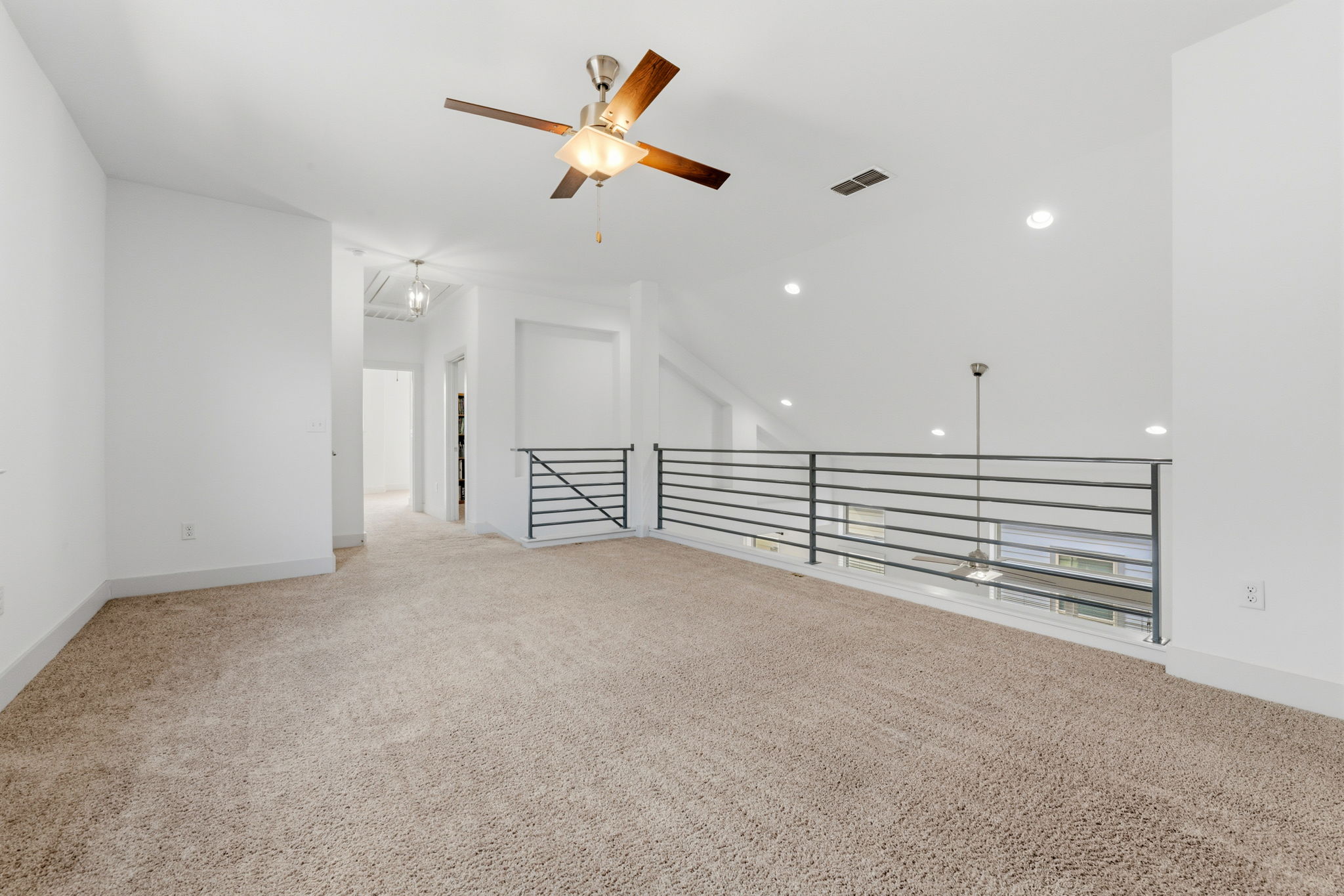 1007 Totis Road Austin, TX 78748 - Photo 29 of 37 wooden floor in an empty room with a ceiling fan and window