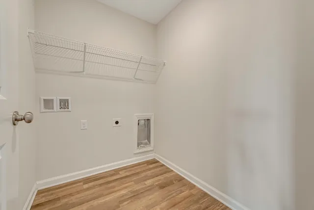 a view of a room with wooden floor