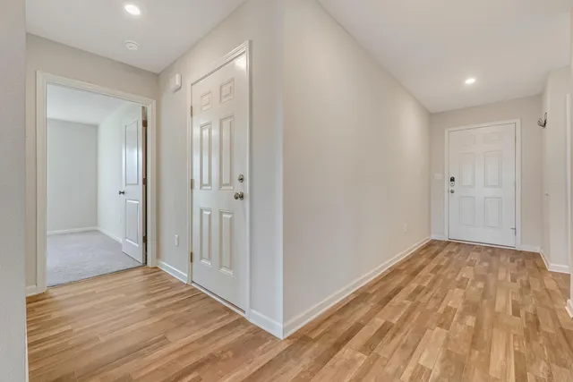 a view of a hallway with wooden floor