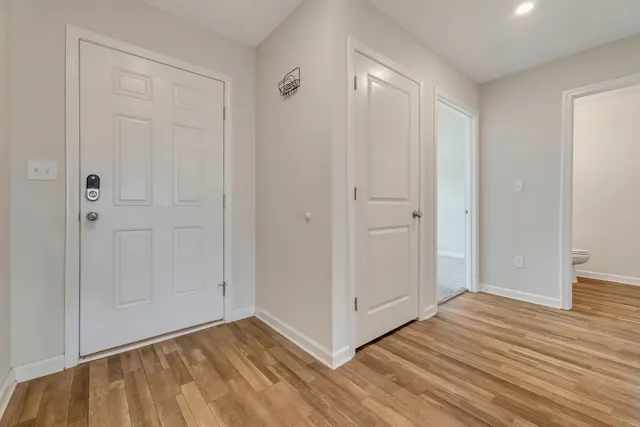 a view of an empty room with wooden floor