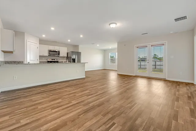 a view of a kitchen with kitchen island and wooden floor