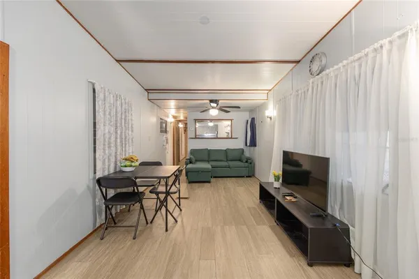 a view of a livingroom with furniture and a flat screen tv