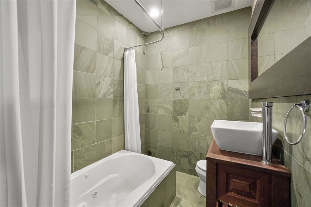 96 South Street, Unit 3 Boston, MA 02111 - Photo 14 of 17 a bathroom with a sink a toilet and shower