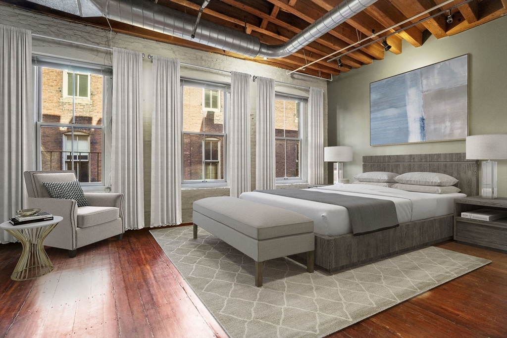 96 South Street, Unit 3 Boston, MA 02111 - Photo 5 of 17 a bedroom with a large bed and a couch