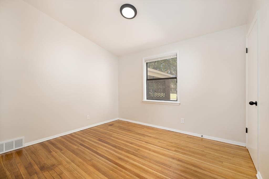4512 Applegate Road Memphis, TN 38109 - Photo 15 of 31 a view of a room with wooden floor and white walls