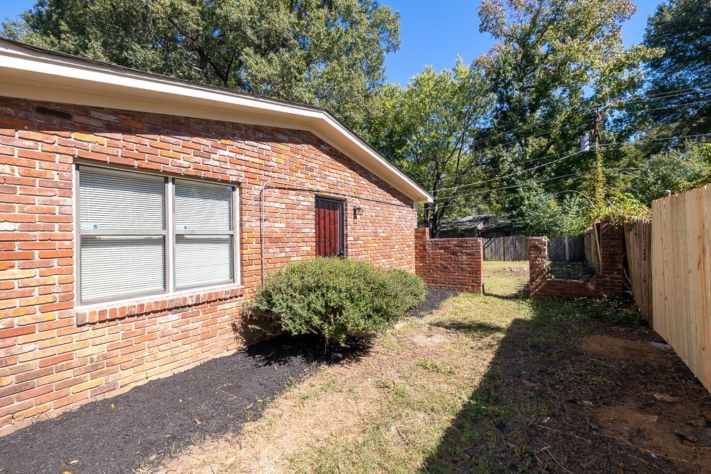 4512 Applegate Road Memphis, TN 38109 - Photo 16 of 31 a view of a backyard with plants and large trees