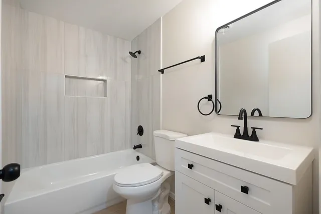 a bathroom with a sink a toilet and a mirror