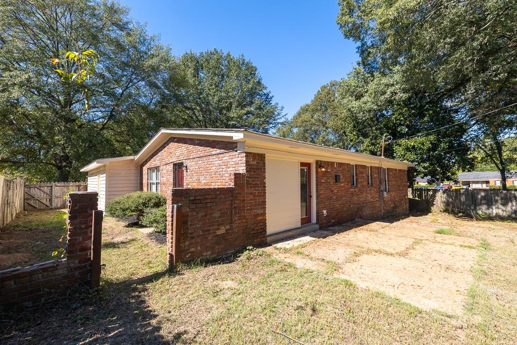 4512 Applegate Road Memphis, TN 38109 - Photo 26 of 31 a front view of a house with a yard covered in snow