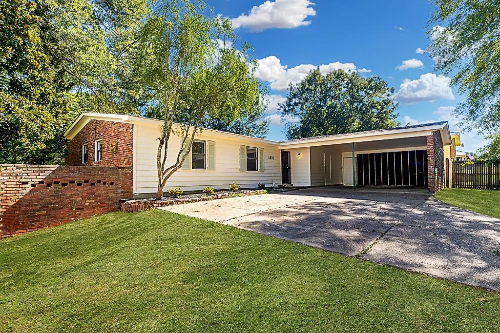 4512 Applegate Road Memphis, TN 38109 - Photo 7 of 31 a view of a yard with a house and a tree