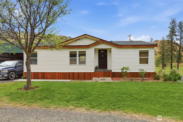 a front view of house with yard and green space