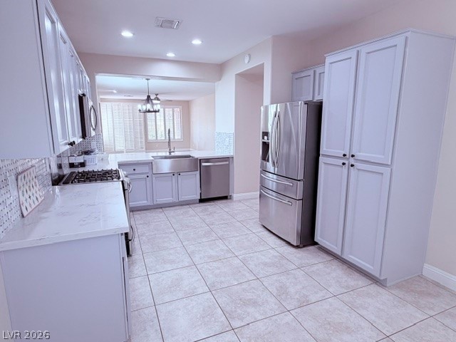 19 Mohansic Road Henderson, NV 89052 - Photo 8 of 30 Gleaming tiled floors and abundant cabinetry define this bright, functional kitchen space.