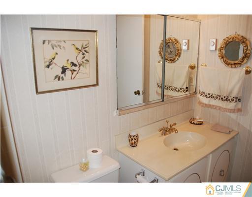 744 A Pompton Road Monroe Township, NJ 08831 - Photo 14 of 16 a bathroom with a sink mirror and vanity
