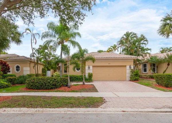 a front view of a house with a yard and a garage