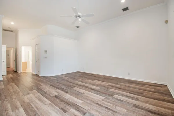 a view of empty room with wooden floor
