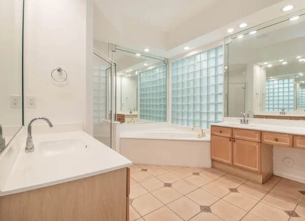a large bathroom with a sink mirror and a shower