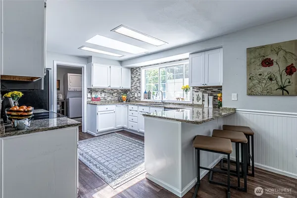 a kitchen with a sink cabinets and window