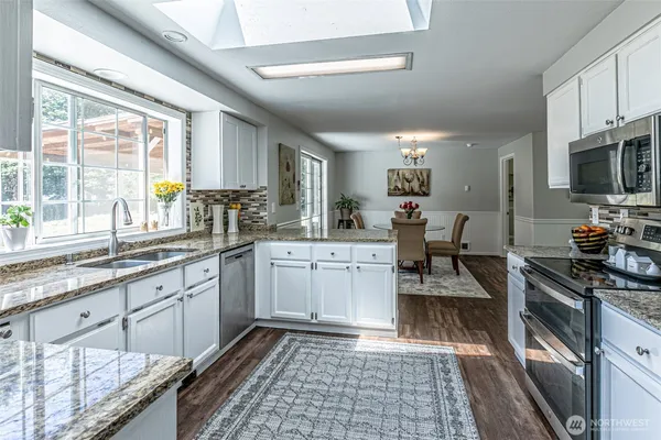 a kitchen with sink cabinets and appliances
