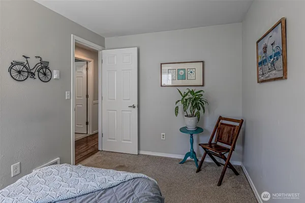 a bedroom with a bed and a chair