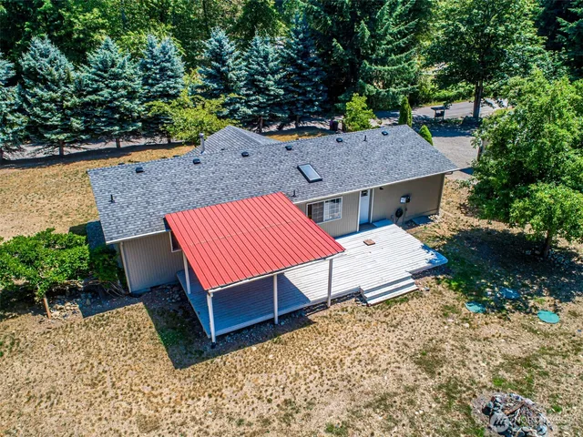 an aerial view of a house with a yard and sitting area