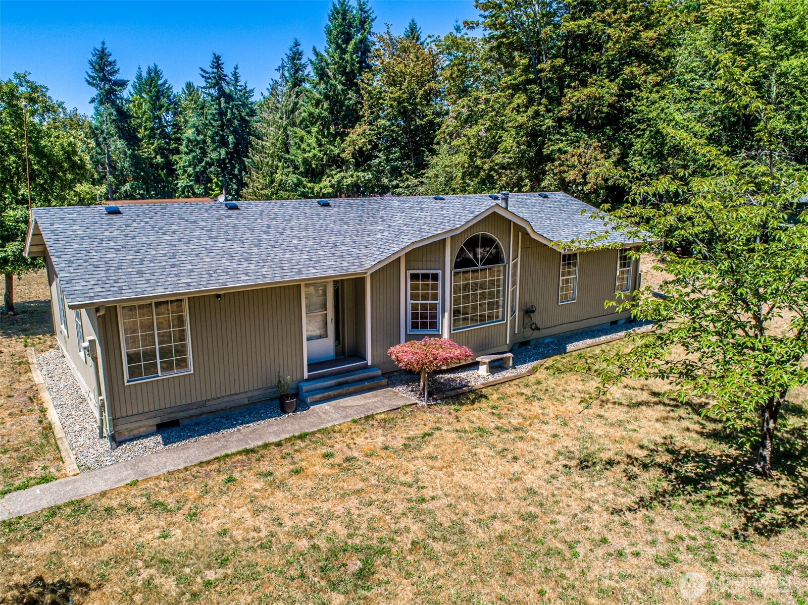 18920 217th Avenue East Orting, WA 98360 - Photo 33 of 36 a front view of a house with a garden and deck