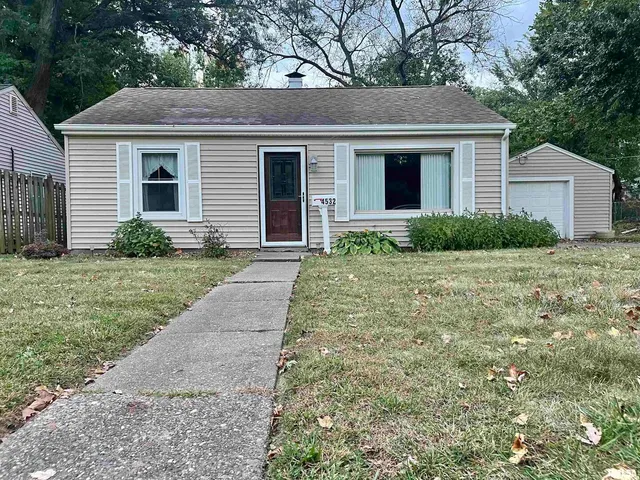 a view of house with a yard