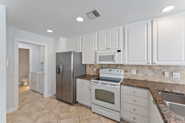 a kitchen with granite countertop cabinets and steel stainless steel appliances