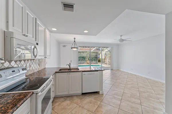 a kitchen with a sink and a stove top oven