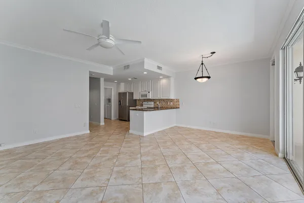 a view of a kitchen with a sink and a refrigerator