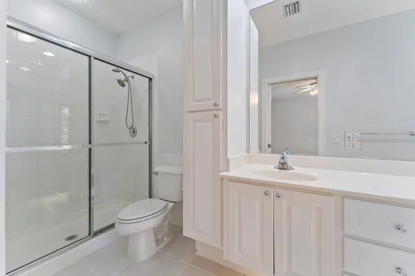 a bathroom with a toilet a sink and shower