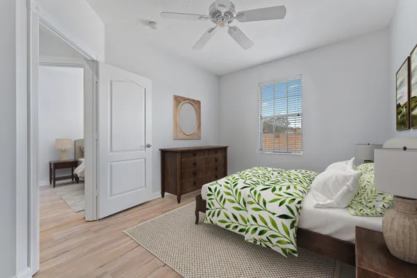 a bedroom with a bed and a chandelier
