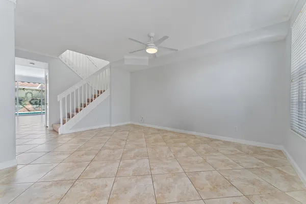 a view of an empty room with staircase