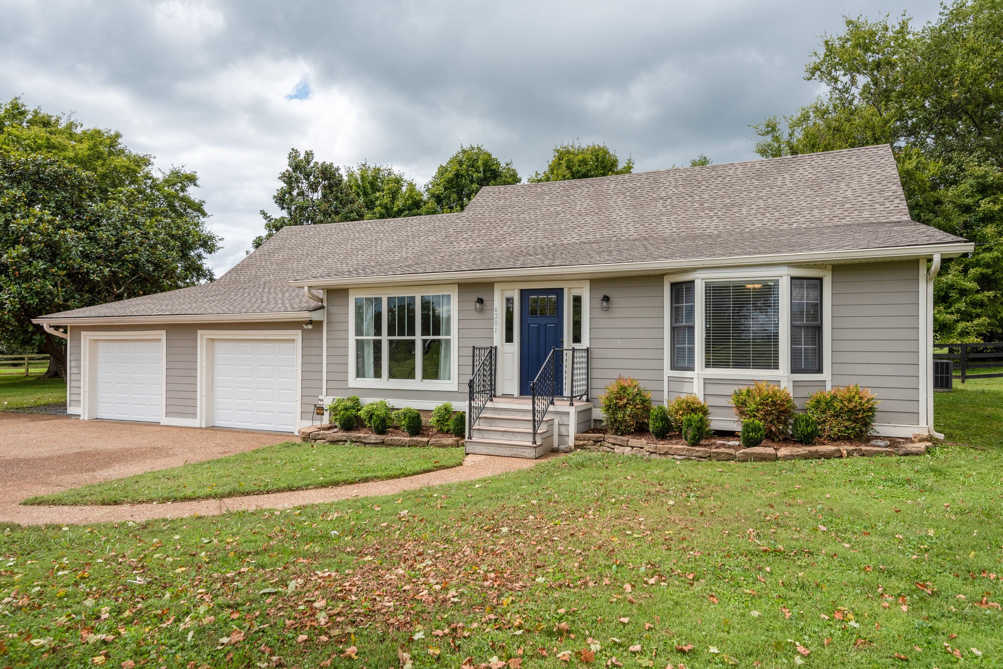 a front view of a house with a yard and porch