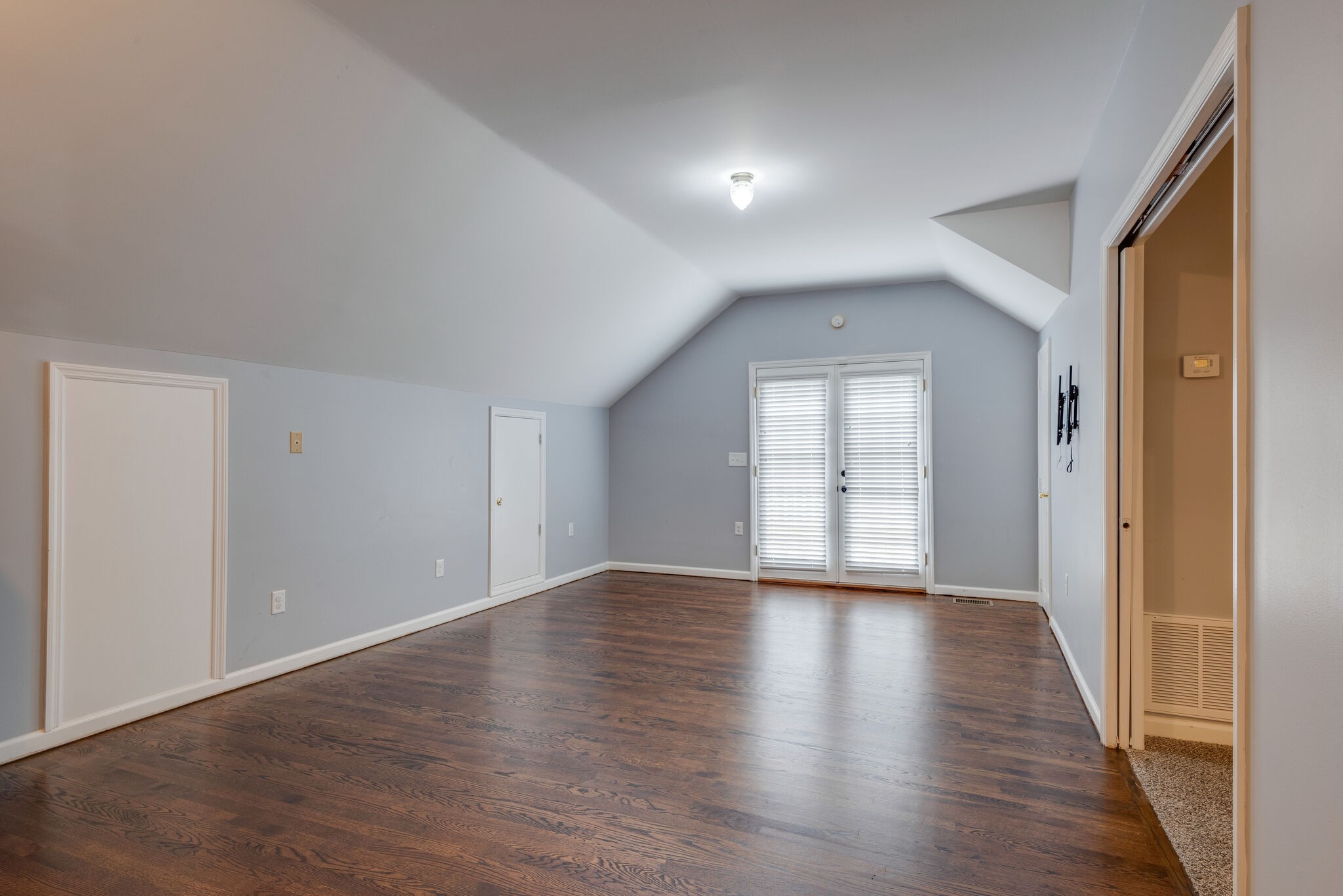 6201 Ladd Road Franklin, TN 37067 - Photo 18 of 28 a view of an empty room with wooden floor and a window