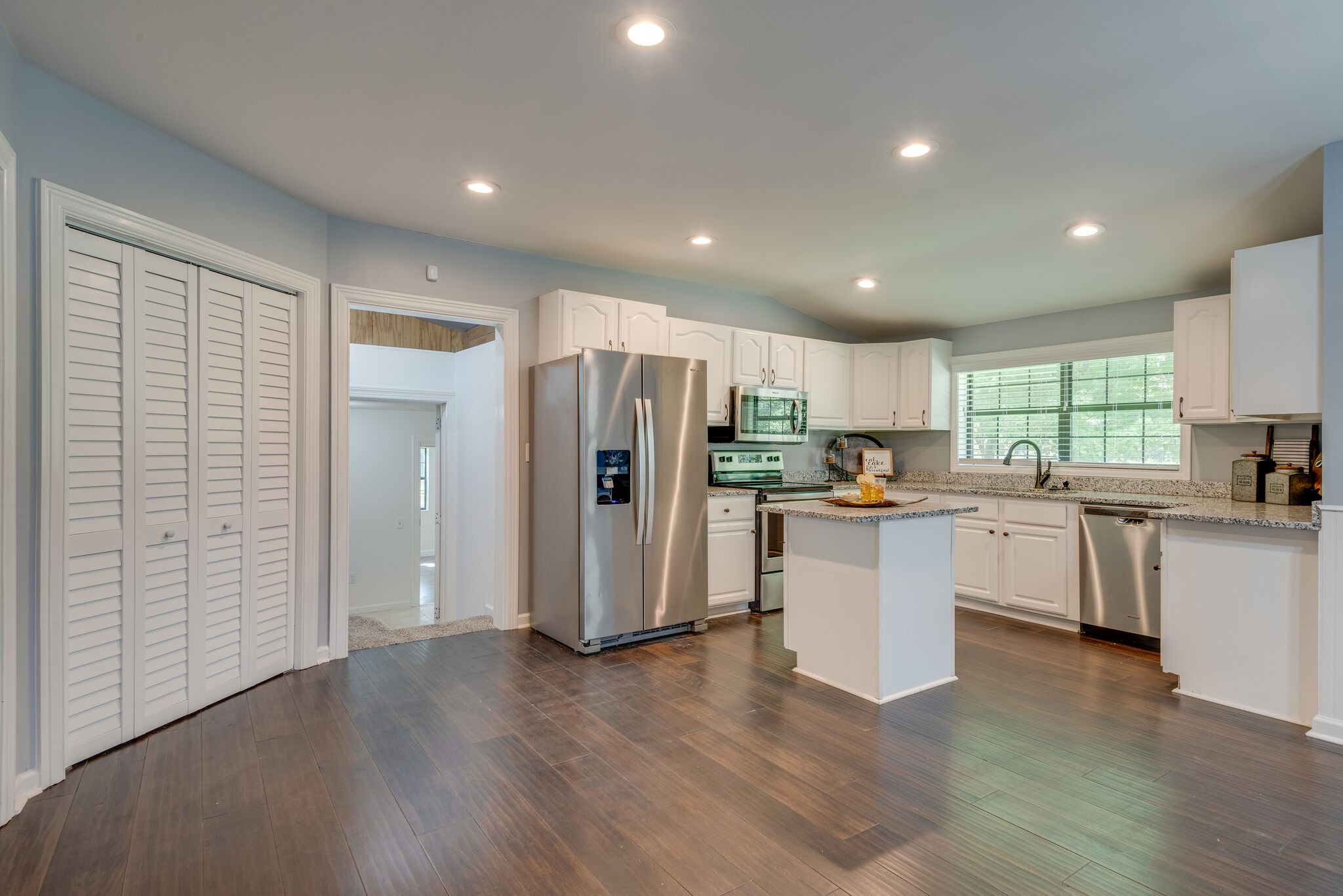 6201 Ladd Road Franklin, TN 37067 - Photo 9 of 28 a kitchen with a refrigerator and white cabinets