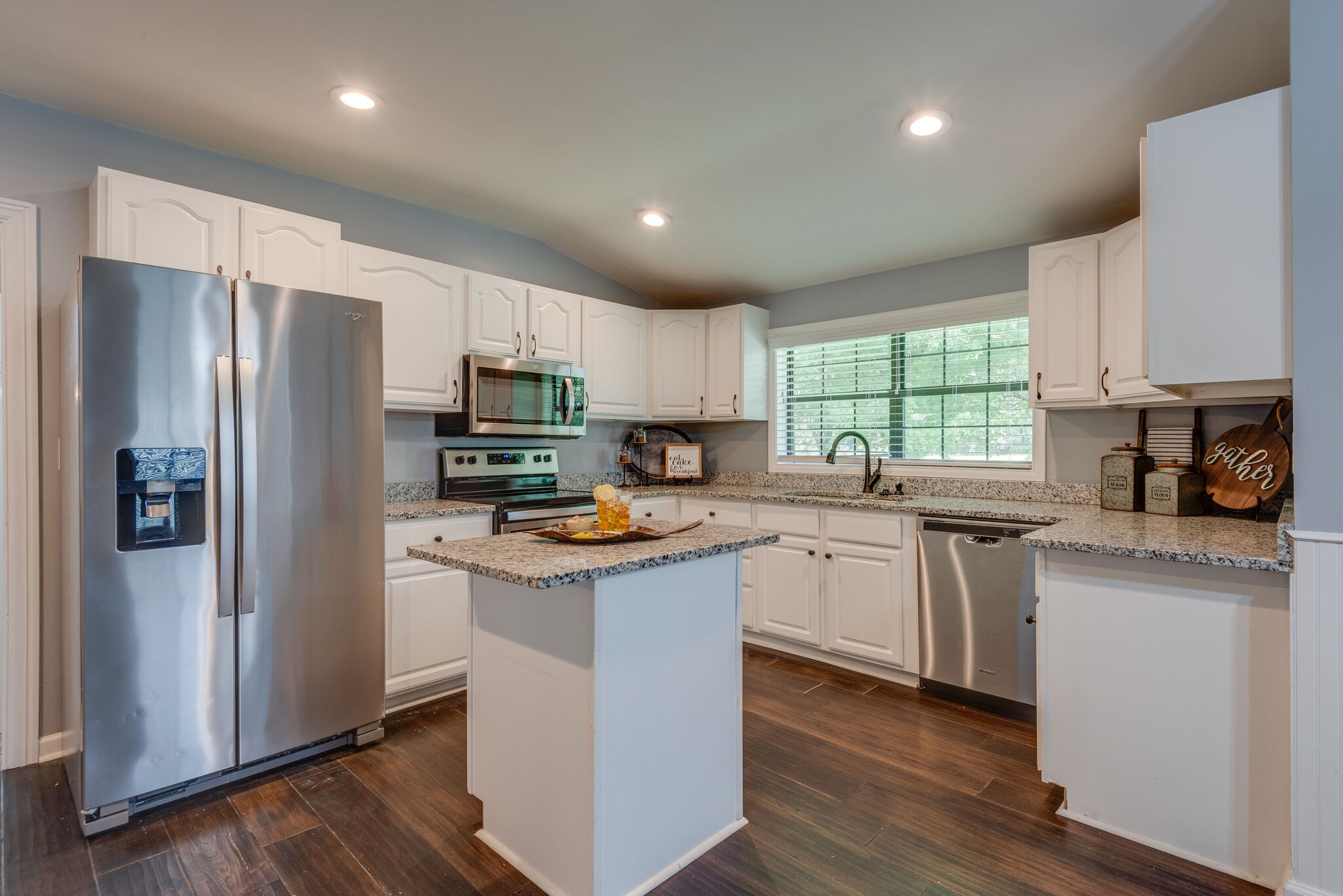 6201 Ladd Road Franklin, TN 37067 - Photo 10 of 28 a kitchen with stainless steel appliances granite countertop a refrigerator a sink dishwasher a stove and white cabinets with wooden floor