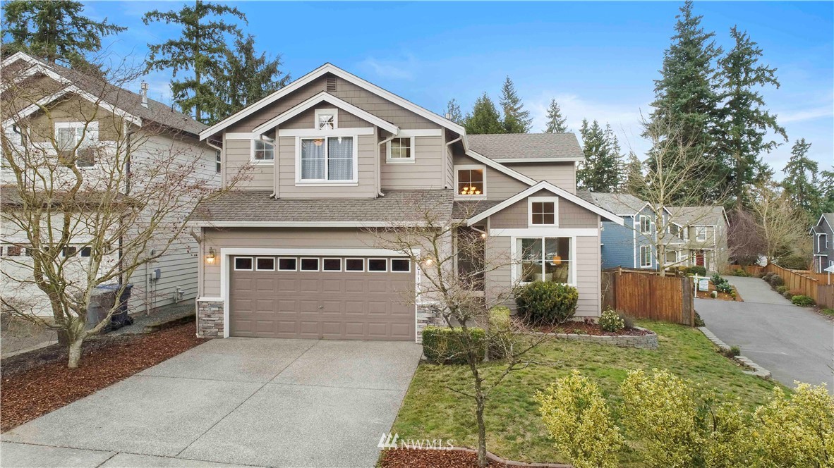 a front view of a house with a yard and garage
