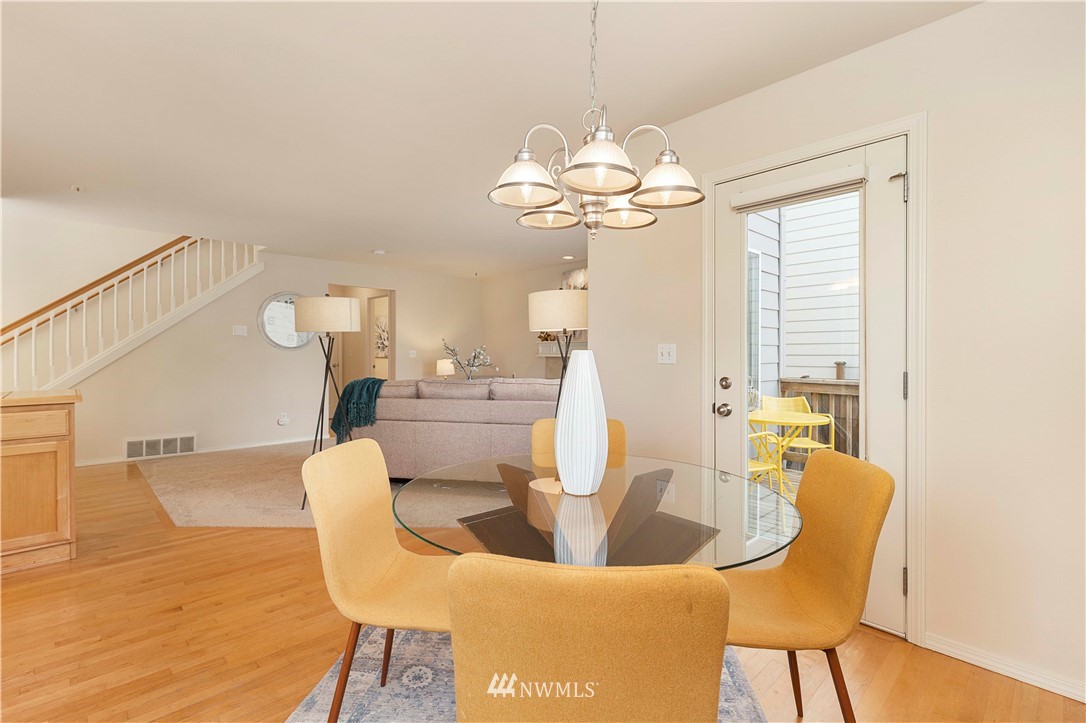 20117 Bartlett Road Bothell, WA 98012 - Photo 14 of 32 a view of a dining room with furniture wooden floor and chandelier