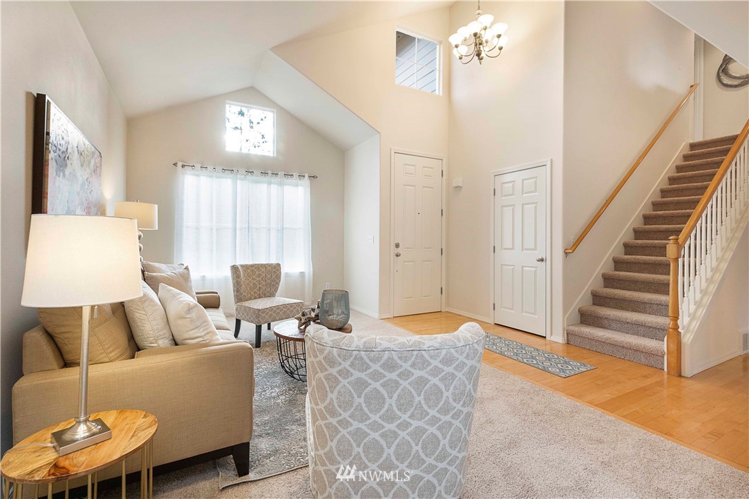 20117 Bartlett Road Bothell, WA 98012 - Photo 5 of 32 a living room with furniture and a chandelier