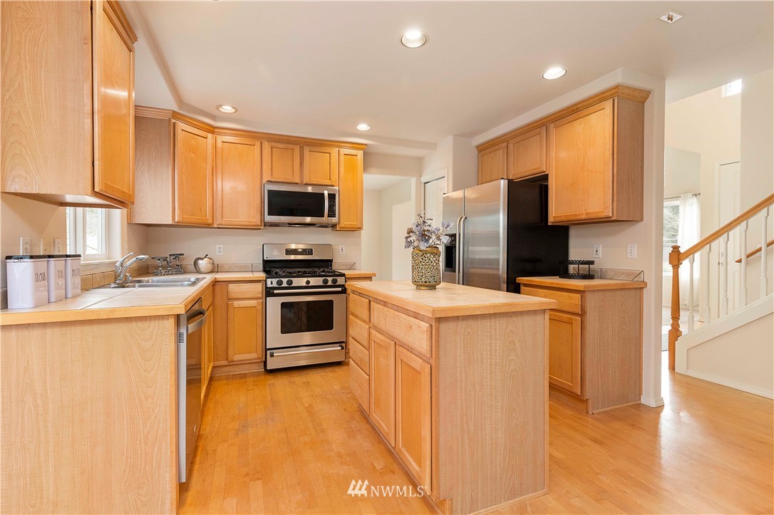 20117 Bartlett Road Bothell, WA 98012 - Photo 9 of 32 a kitchen with a stove a sink and a refrigerator