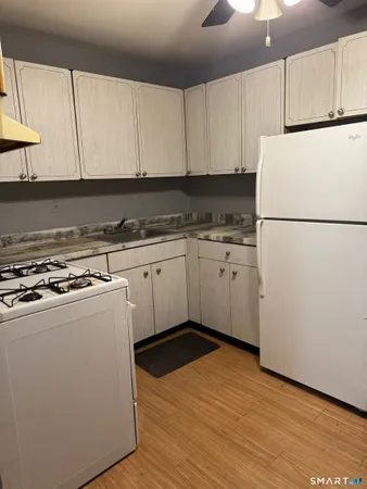 a kitchen with a sink a stove and refrigerator