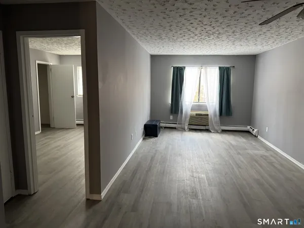 a view of a room with wooden floor