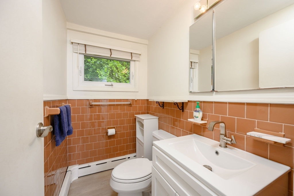 13 Smith Road Hingham, MA 02043 - Photo 12 of 32 a bathroom with a sink a toilet and shower curtain