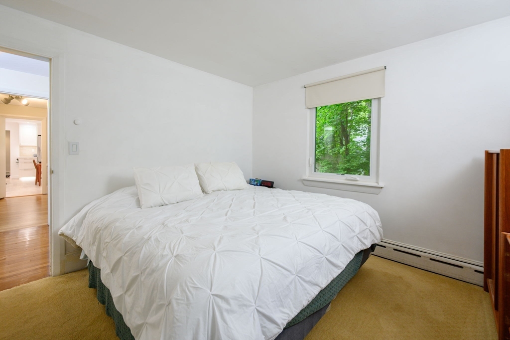 13 Smith Road Hingham, MA 02043 - Photo 16 of 32 a large bed sitting in a bedroom next to a window