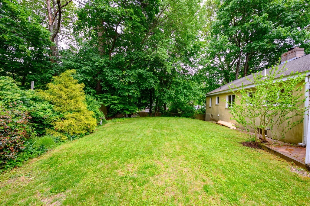 13 Smith Road Hingham, MA 02043 - Photo 29 of 32 a backyard of a house with plants and large trees