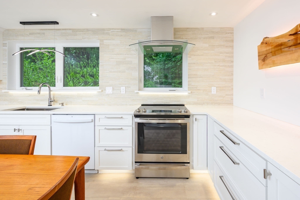 13 Smith Road Hingham, MA 02043 - Photo 5 of 32 a kitchen with a stove a sink and a microwave