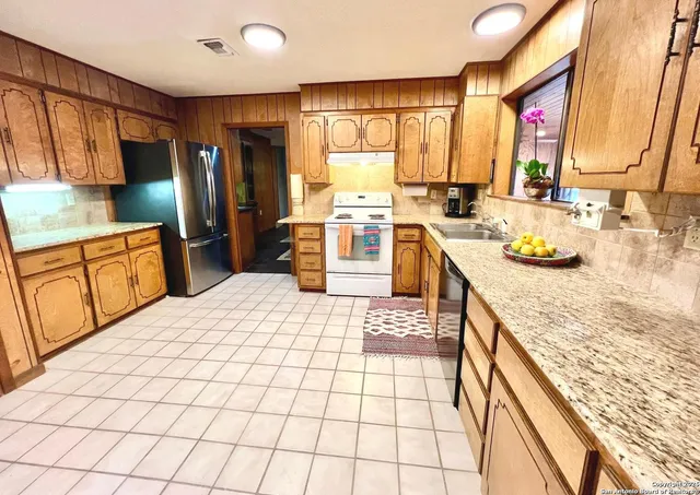a kitchen with a sink stove and cabinets
